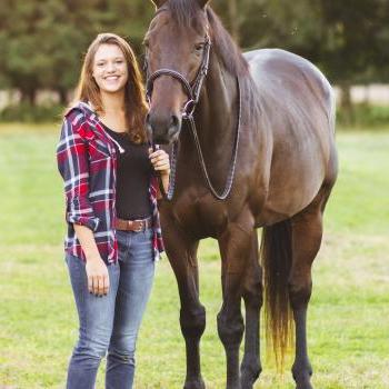 Becca Von Eiff stands with a horse in a green field